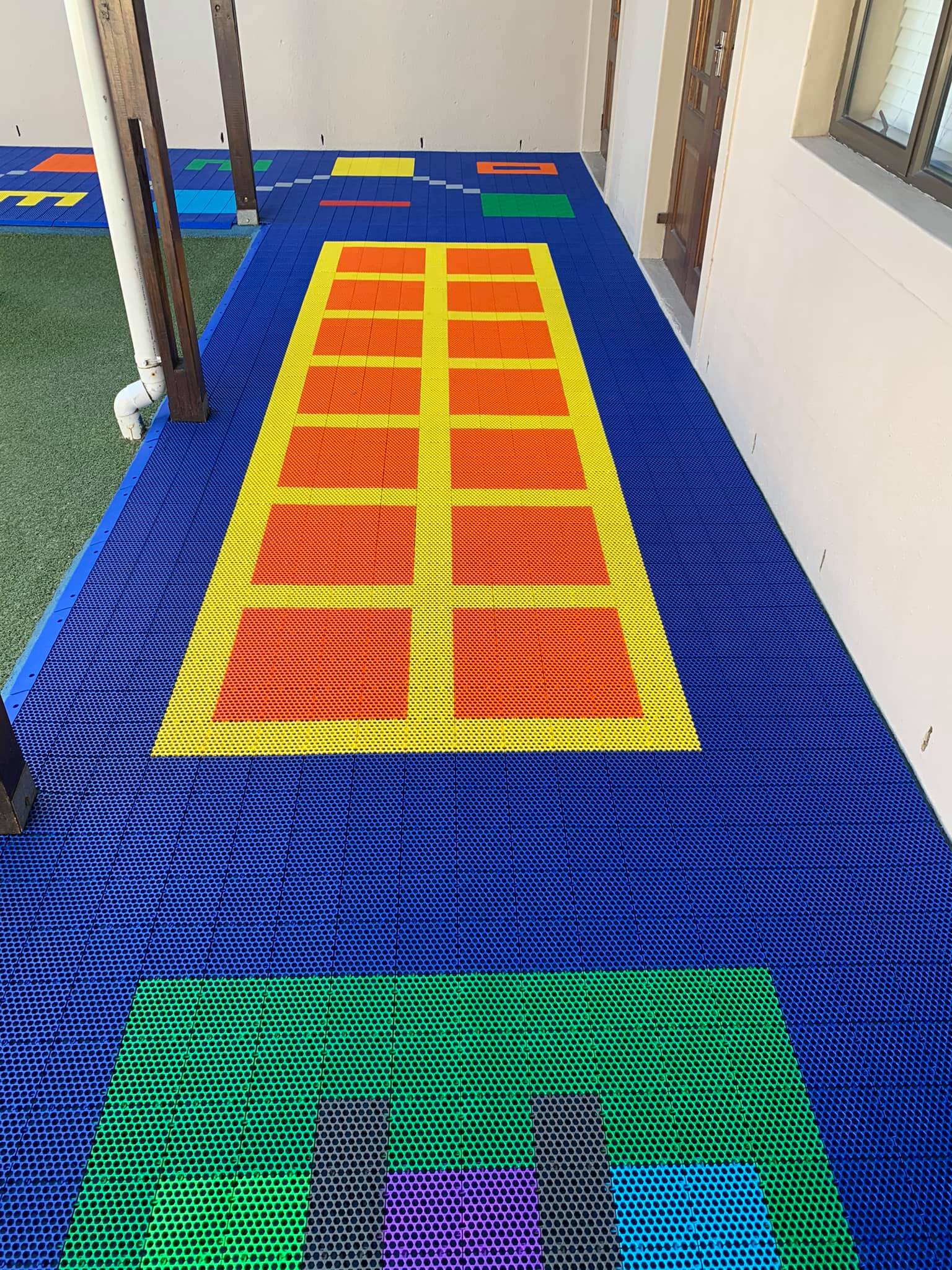 Colourful modular playground floor tiles