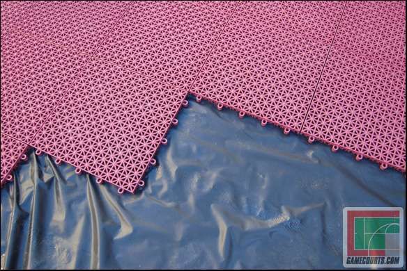 Pink interlocking sports floor tiles installed over waterproof base sheet
