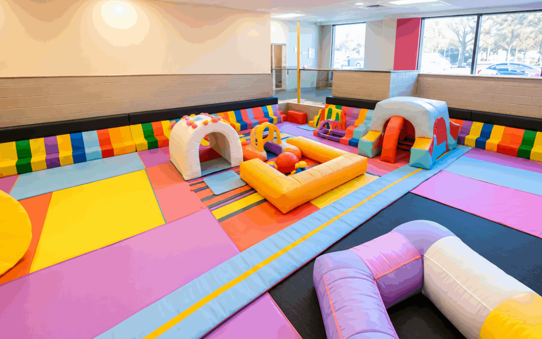 Colourful soft flooring for toddlers in a large indoor playroom with padded play equipment