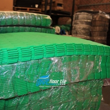 Green coin-pattern interlocking floor tiles manufactured in South Africa