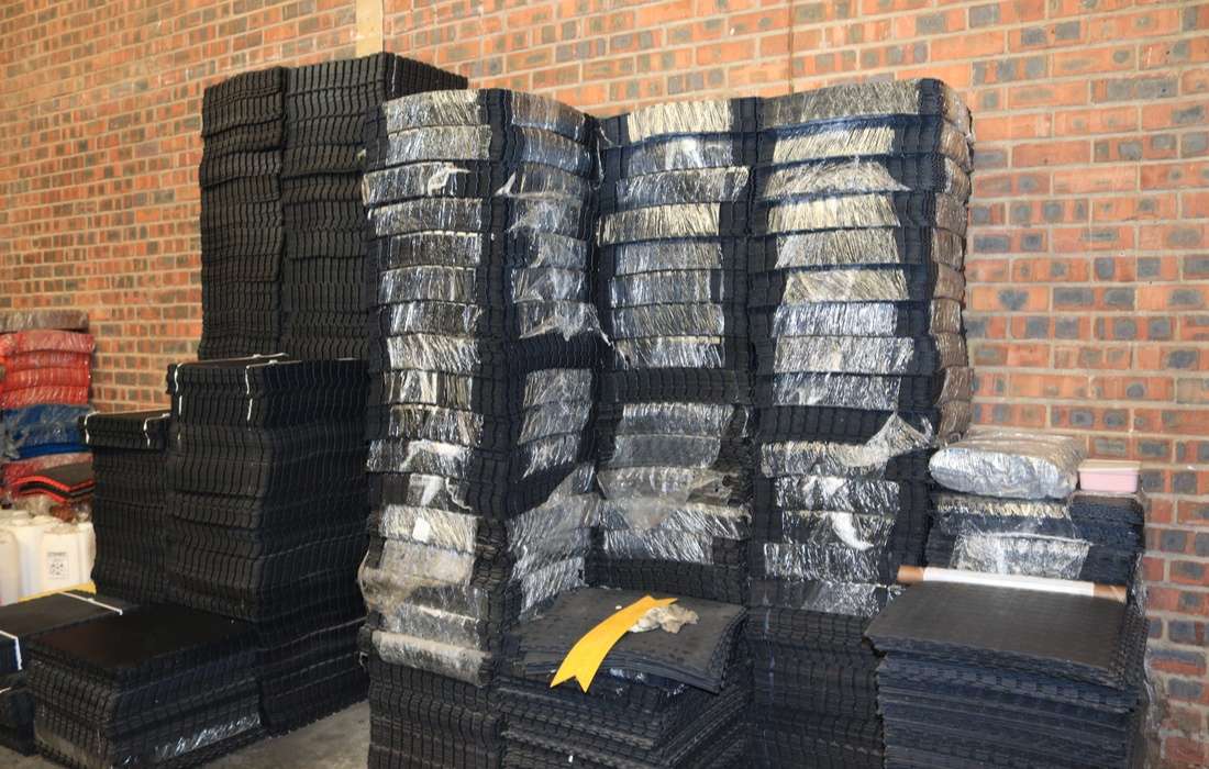 Stacks of interlocking PVC floor tiles stored in the PVC Floor Tile warehouse
