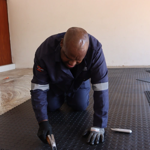 Installing interlocking rubber tiles in double garage