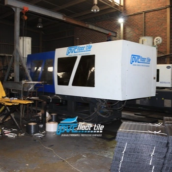 PVC floor tile manufacturing machine inside an industrial factory