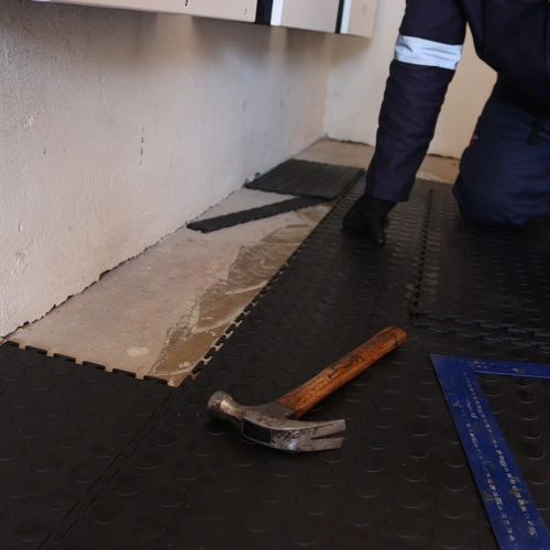 Rubber tile edging and finishing during garage installation