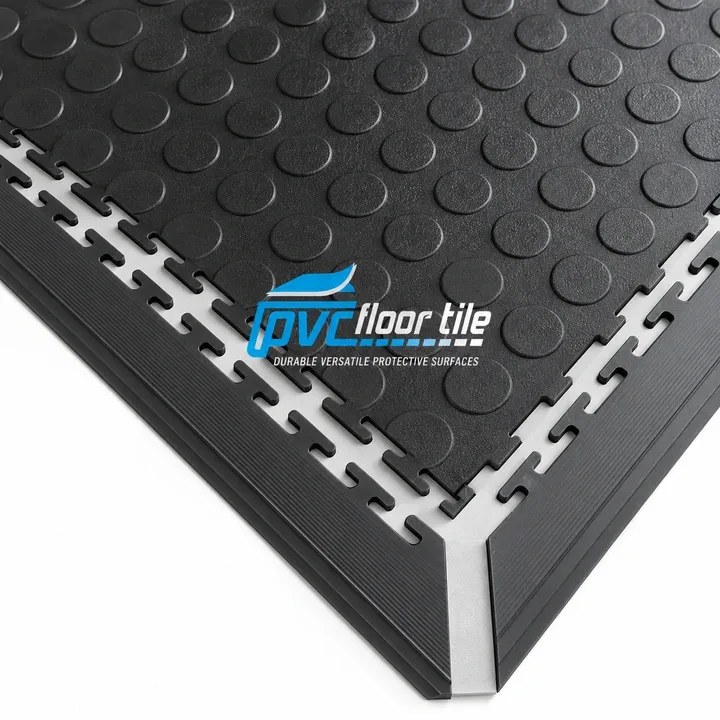 Black PVC interlocking floor tile with raised coin surface and edging trim