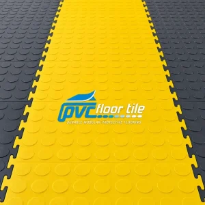 Yellow and charcoal interlocking PVC floor tiles with raised coin surface