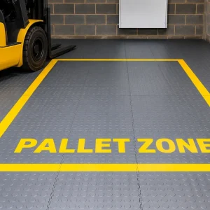 Grey interlocking PVC warehouse floor tiles with yellow pallet zone markings